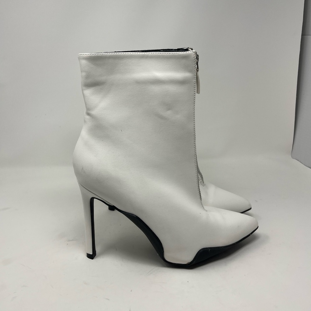 Elegant woman heeled white patent leather boots